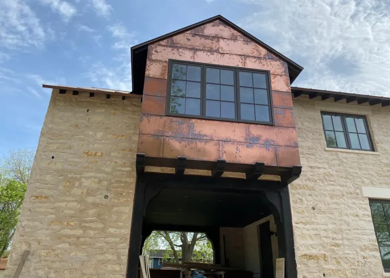 Copper metal panel facade on a stone building for Skylight Installation in South Weber